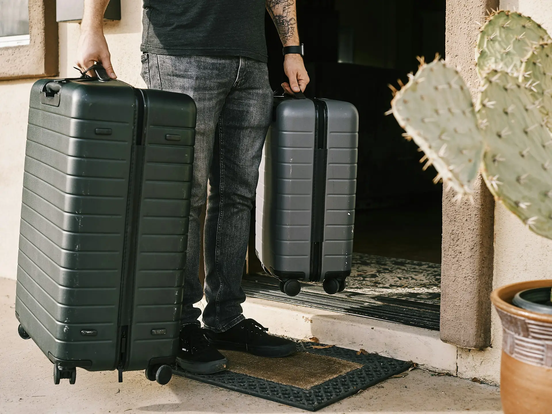 Two suitcases waiting at a doorstep