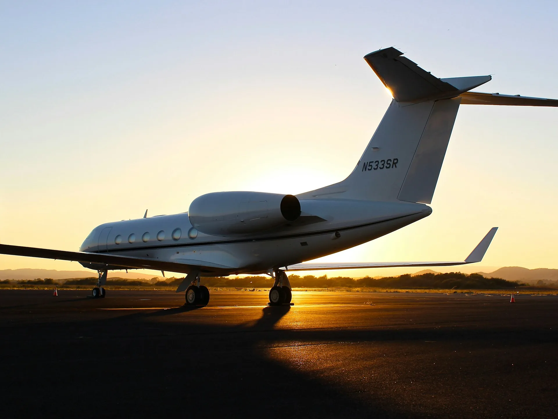 A private jet on the tarmac at golden hour