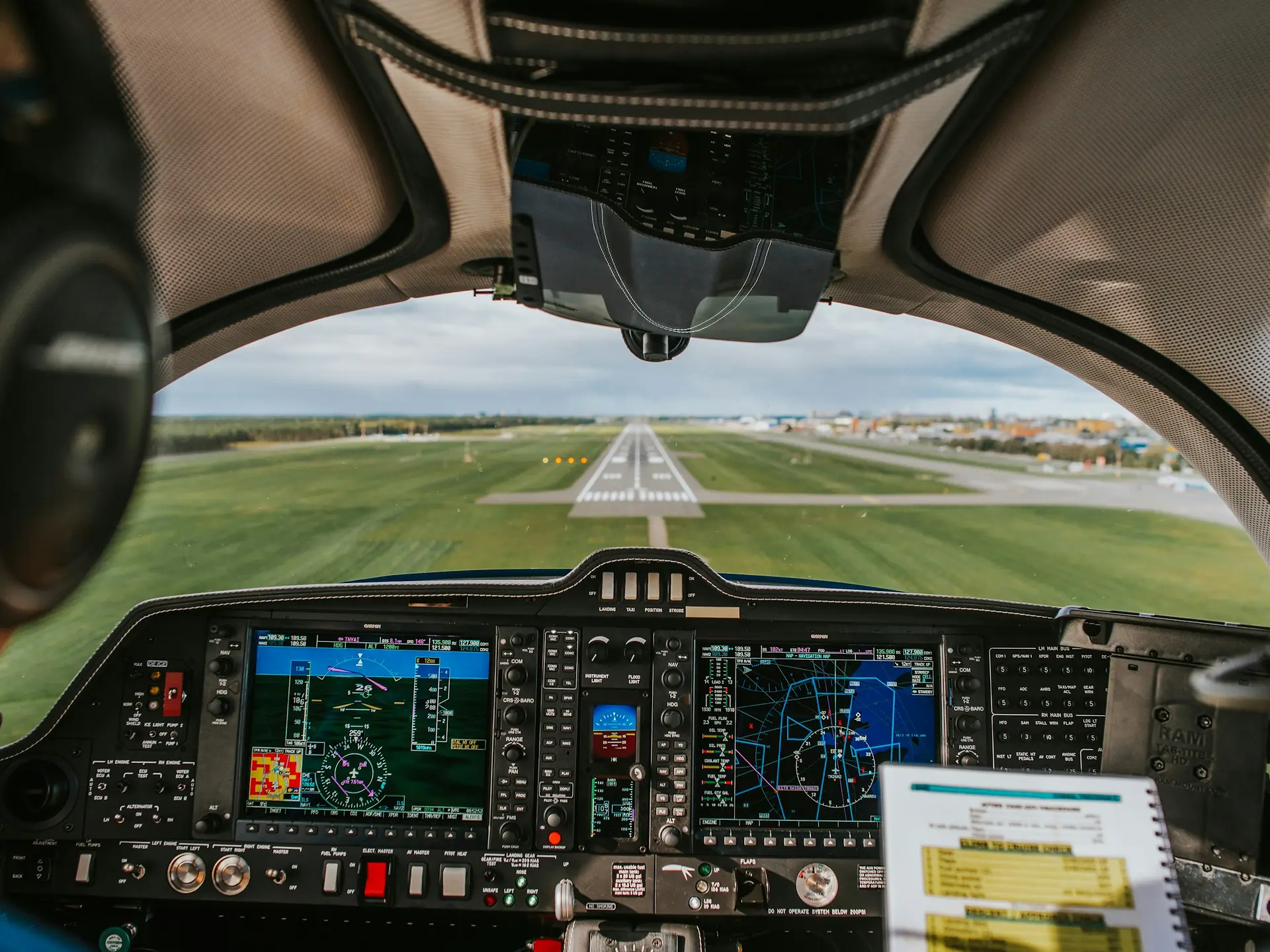 The view from a cockpit on approach to a runway