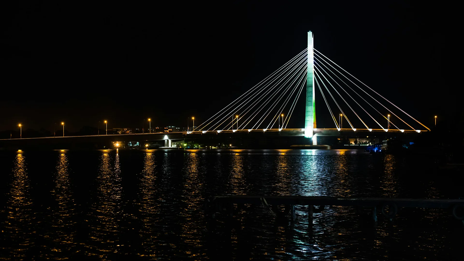 A bridge lit across the water in Lagos at night