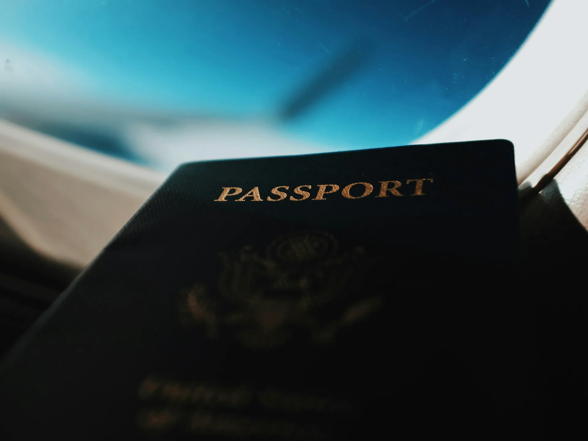 A passport resting against an aircraft window