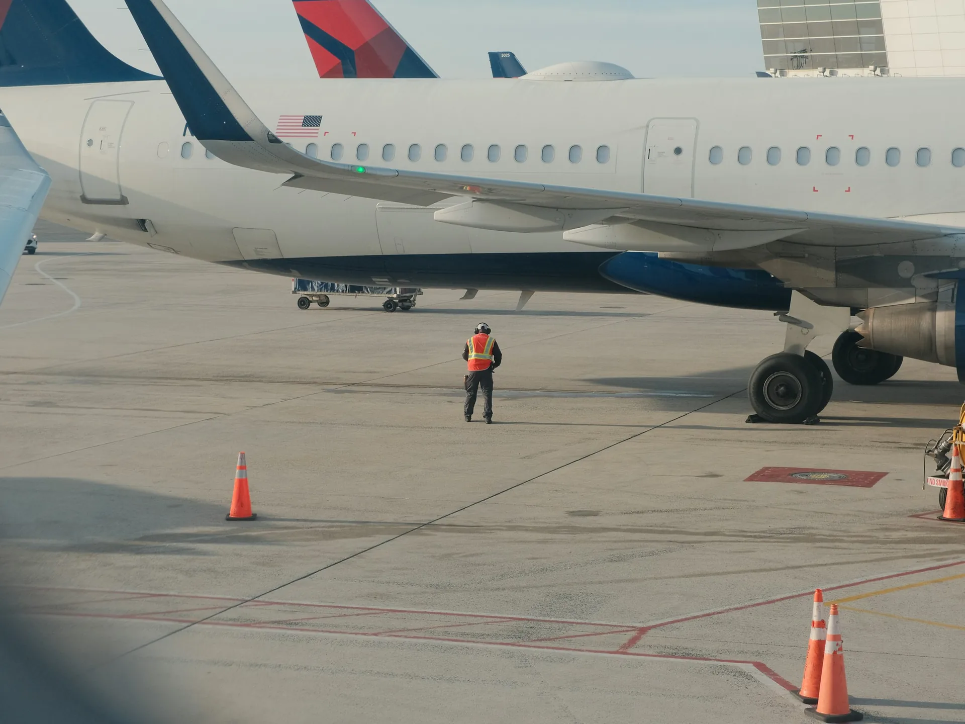 Ground crew working beside an airliner on the apron