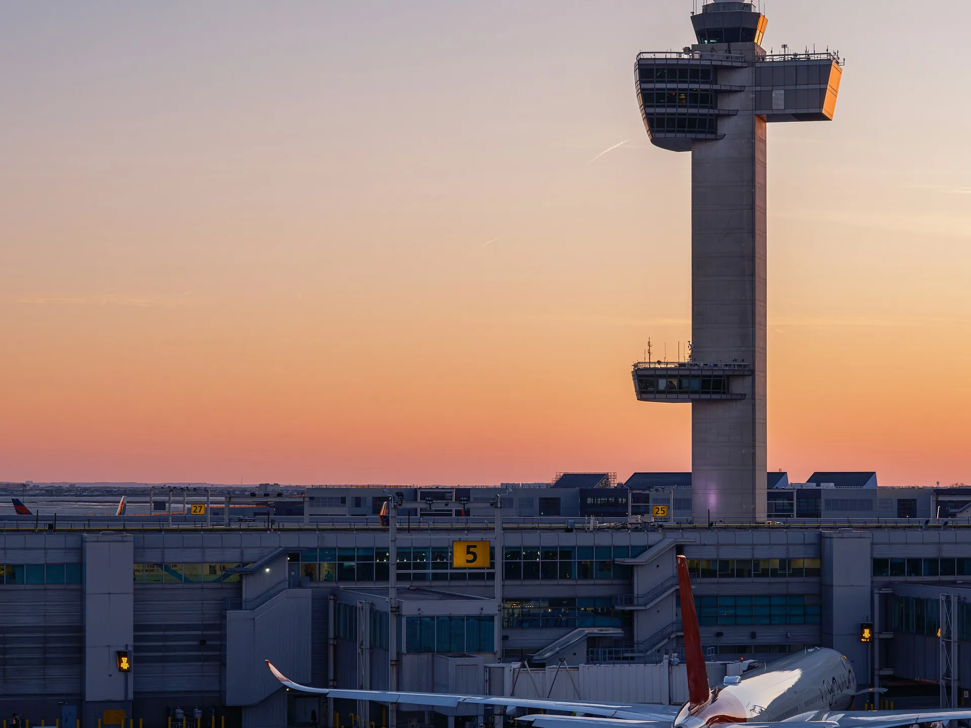 An airport control tower at dusk